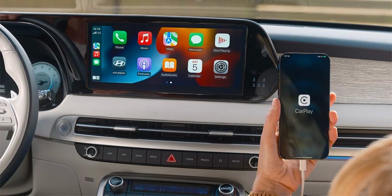 Vehicle infotainment display showing Apple CarPlay connected inside a car