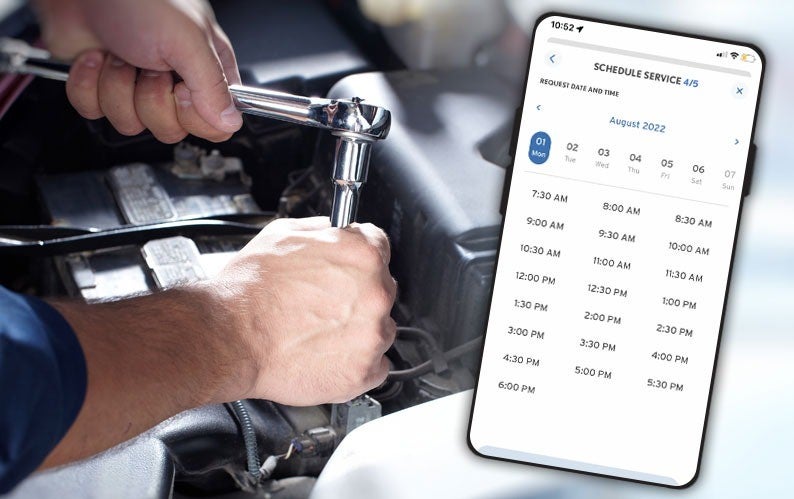 Mechanic working on a car engine, with a smartphone displaying an app for scheduling service overlaid.